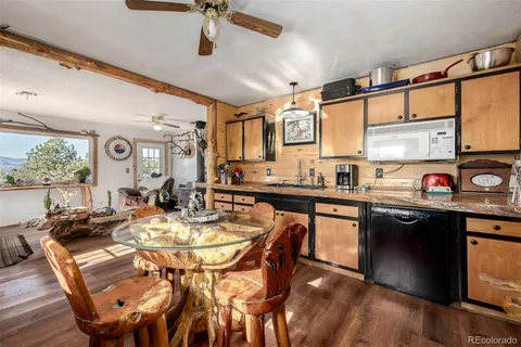 a open kitchen with stainless steel appliances granite countertop a stove a sink and a refrigerator