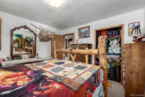 a living room with patio furniture and a flat screen tv