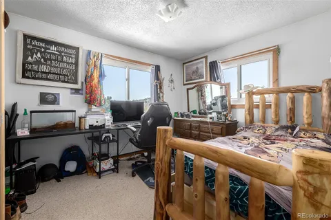 a view of a livingroom with workspace and a window