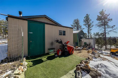 a view of a chair and tables in the backyard