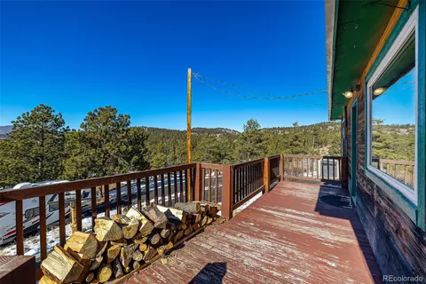 a view of a balcony with wooden floor and fence