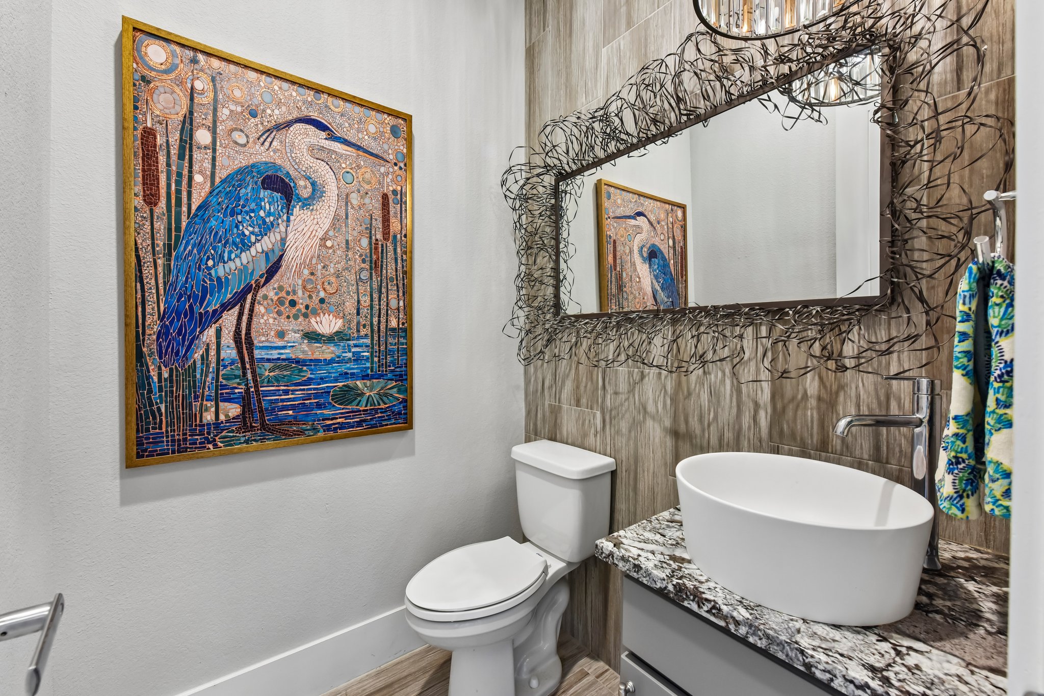 2203 Improver Road Spicewood, TX 78669 - Photo 19 of 38 A stylish half-bath features a contemporary vessel sink atop granite counters, complemented by a unique, nature-inspired mirror.