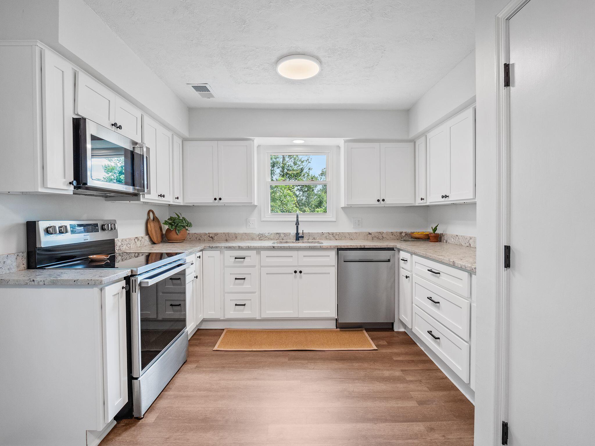 1701 Glendon Road Salem, VA 24153 - Photo 11 of 43 a kitchen with granite countertop white cabinets and white appliances