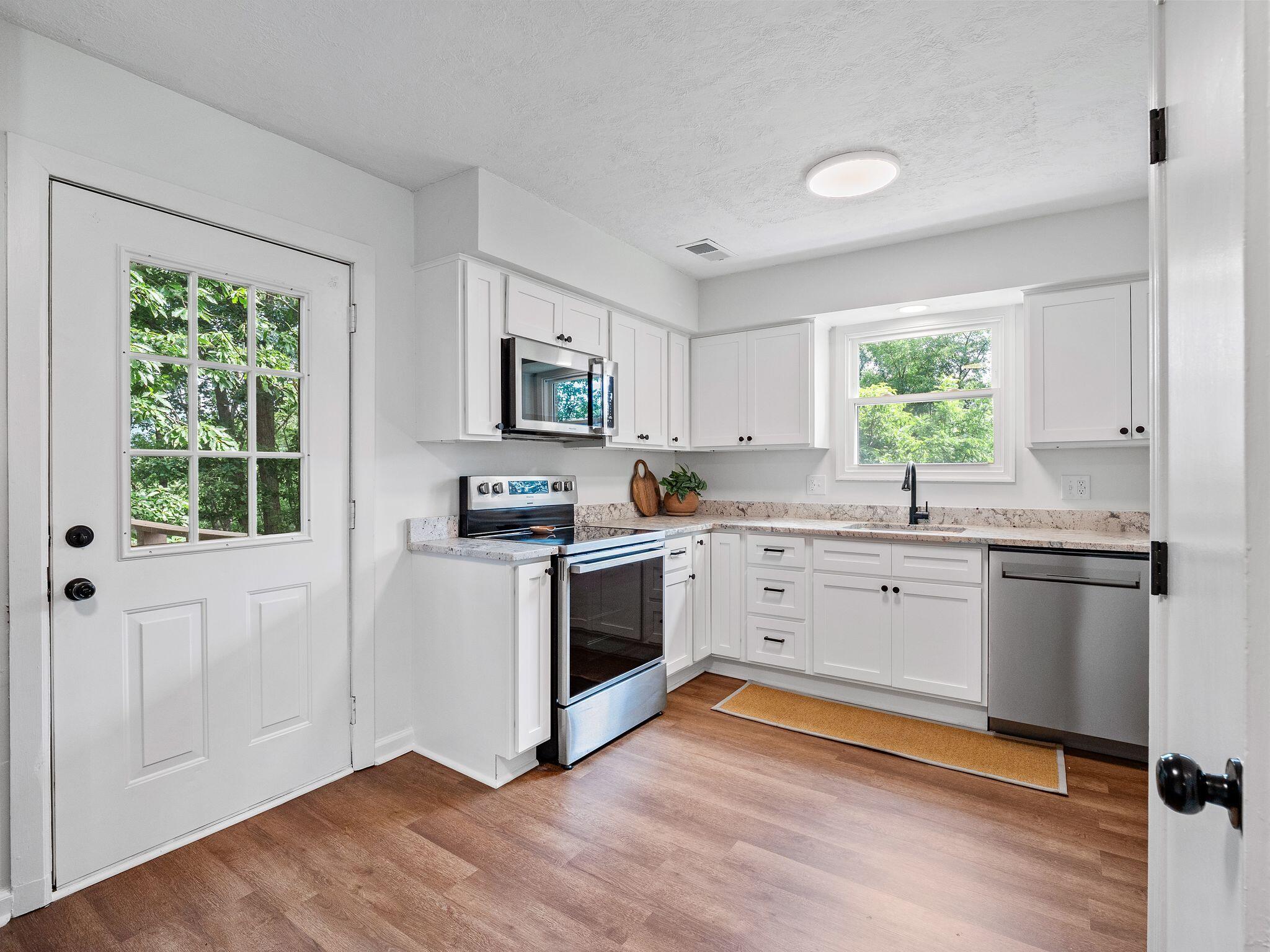 1701 Glendon Road Salem, VA 24153 - Photo 13 of 43 a kitchen with granite countertop white cabinets and white appliances