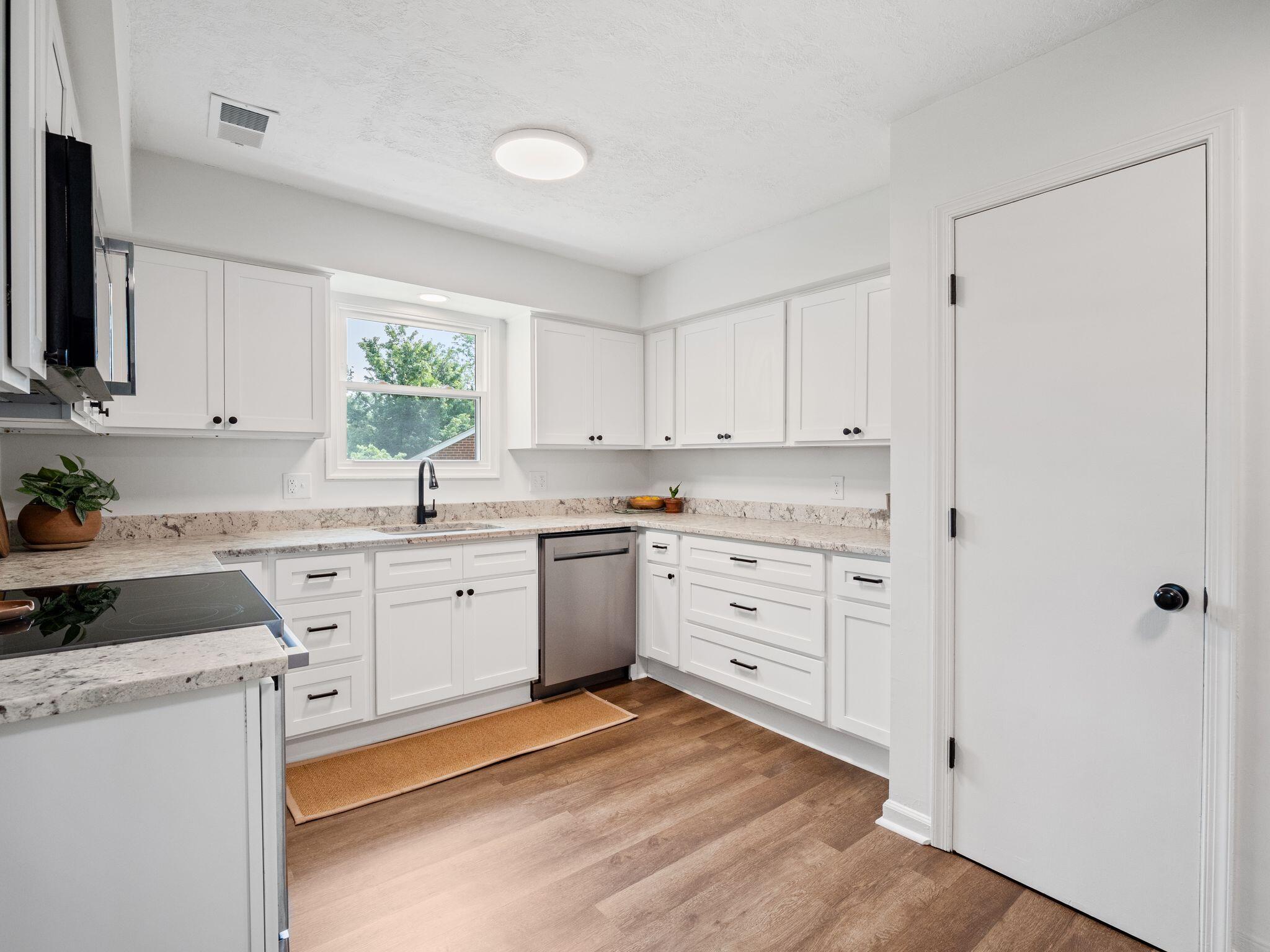 1701 Glendon Road Salem, VA 24153 - Photo 15 of 43 a kitchen with granite countertop white cabinets white stainless steel appliances and sink