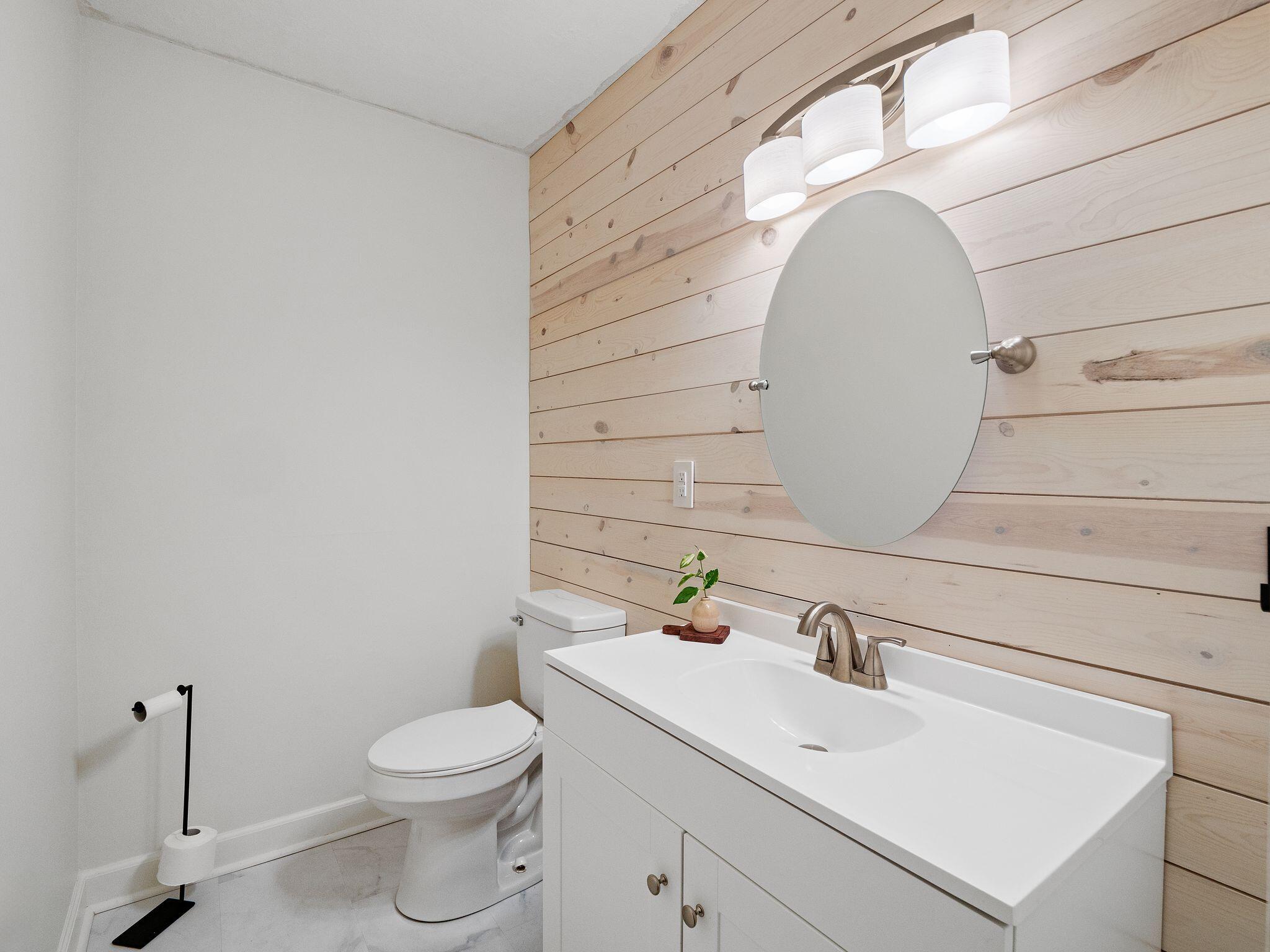 1701 Glendon Road Salem, VA 24153 - Photo 20 of 43 a bathroom with a toilet sink vanity and mirror