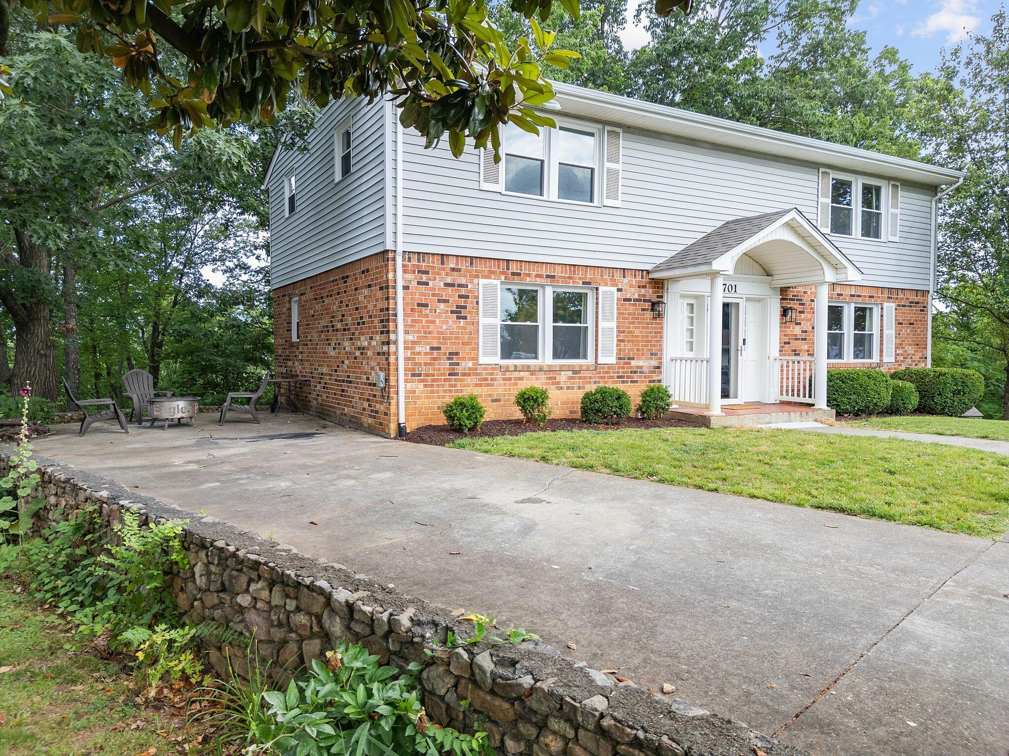 1701 Glendon Road Salem, VA 24153 - Photo 2 of 43 a view of a white house with a yard and large trees