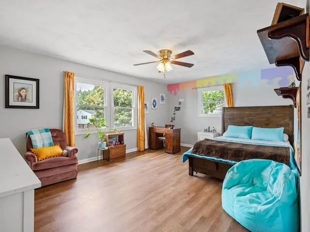 a bedroom with furniture and a large window