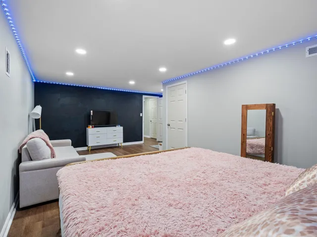 a bedroom with a bed and a couch