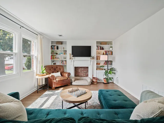 a living room with furniture a fireplace and a flat screen tv