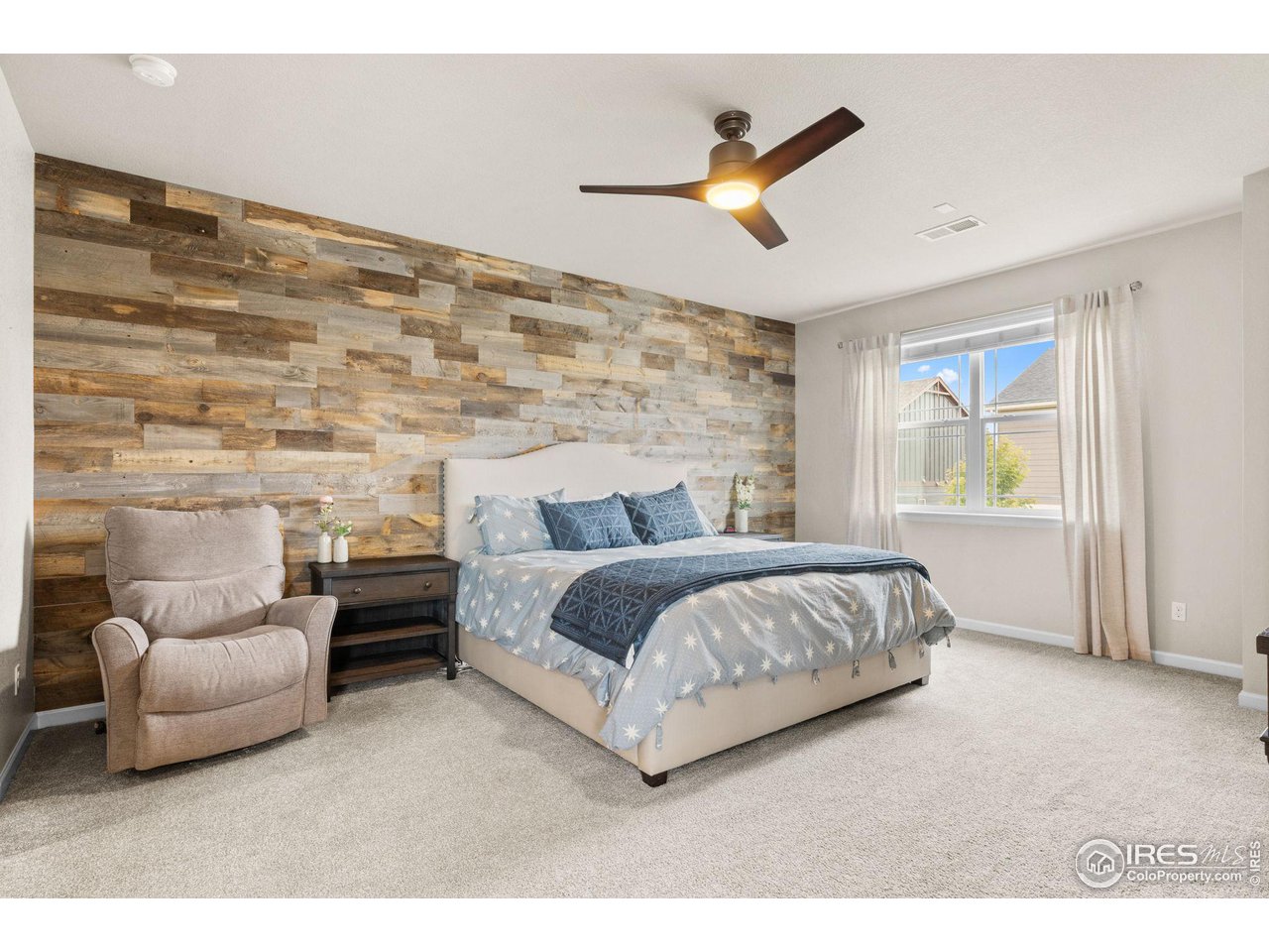 803 Old Wagon Trail Circle Lafayette, CO 80026 - Photo 13 of 30 a spacious bedroom with a bed and a couch