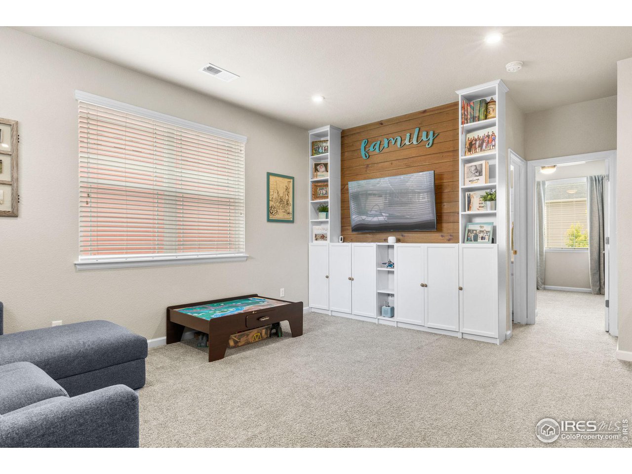 803 Old Wagon Trail Circle Lafayette, CO 80026 - Photo 16 of 30 a living room with furniture and a flat screen tv