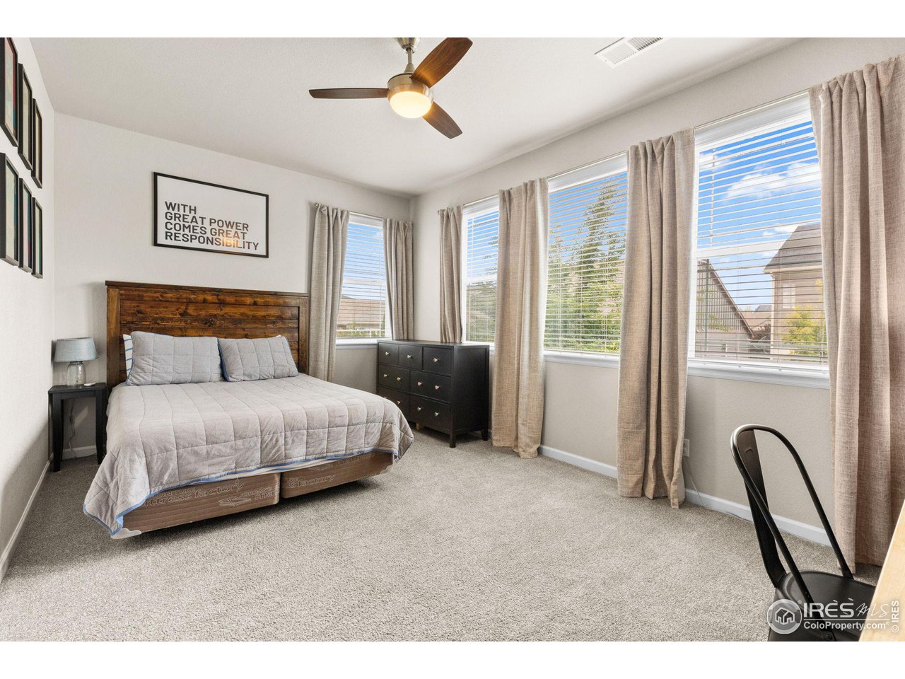 803 Old Wagon Trail Circle Lafayette, CO 80026 - Photo 17 of 30 a bedroom with a bed a couch and a window