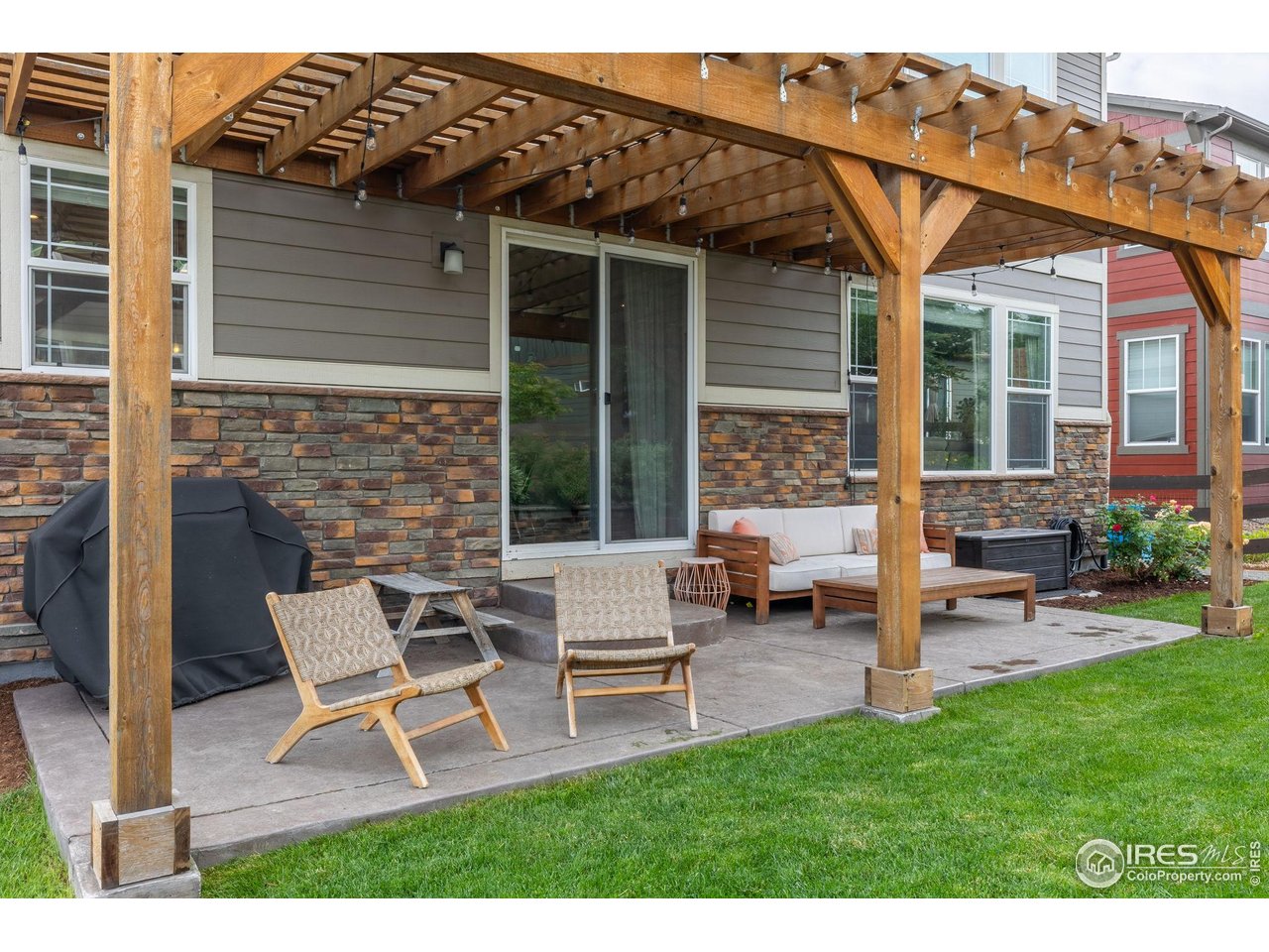 803 Old Wagon Trail Circle Lafayette, CO 80026 - Photo 2 of 30 a view of a house with backyard sitting area and garden