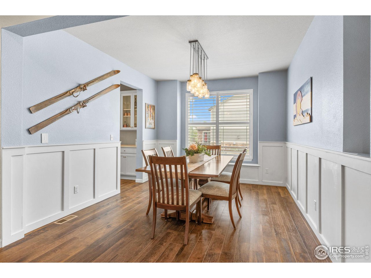 803 Old Wagon Trail Circle Lafayette, CO 80026 - Photo 10 of 30 a dining room with wooden floor a chandelier a wooden table and chairs