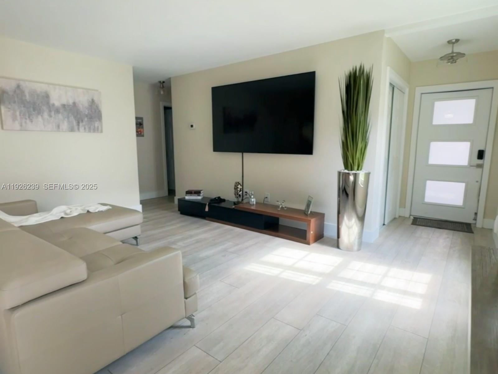 19066 Bob-O-Link Drive Hialeah, FL 33015 - Photo 2 of 11 a living room with furniture and a flat screen tv
