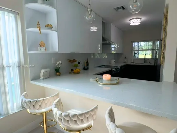 a kitchen with a table and chairs