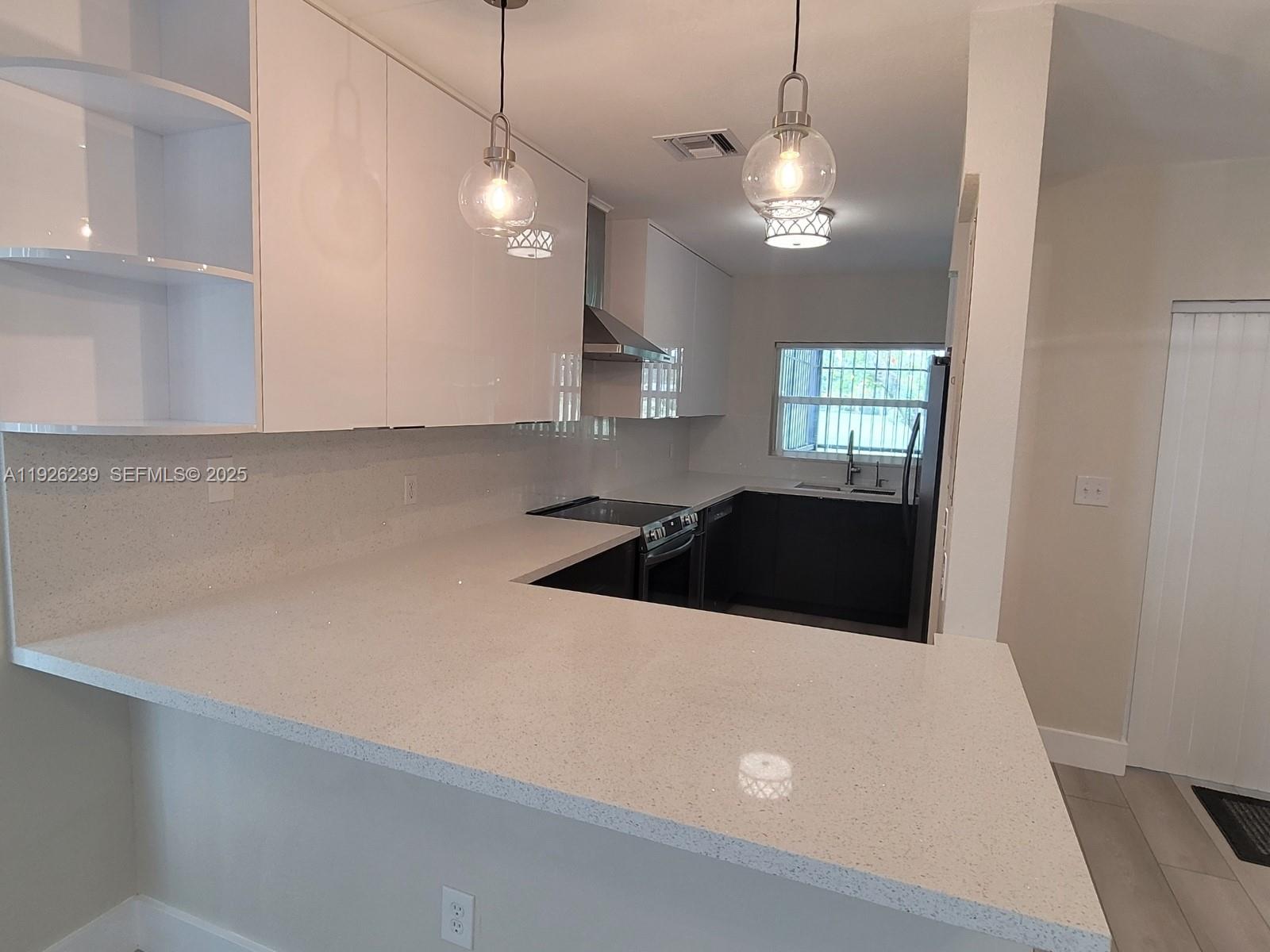 19066 Bob-O-Link Drive Hialeah, FL 33015 - Photo 5 of 11 a kitchen with a refrigerator a stove a sink and a window
