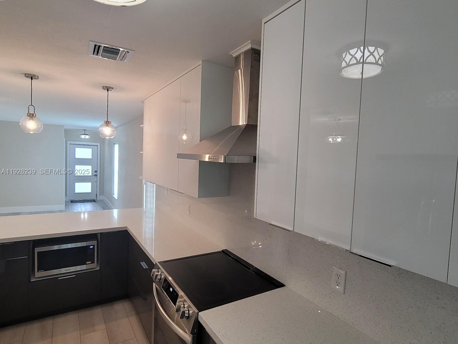 19066 Bob-O-Link Drive Hialeah, FL 33015 - Photo 6 of 11 a kitchen with a stove and a microwave