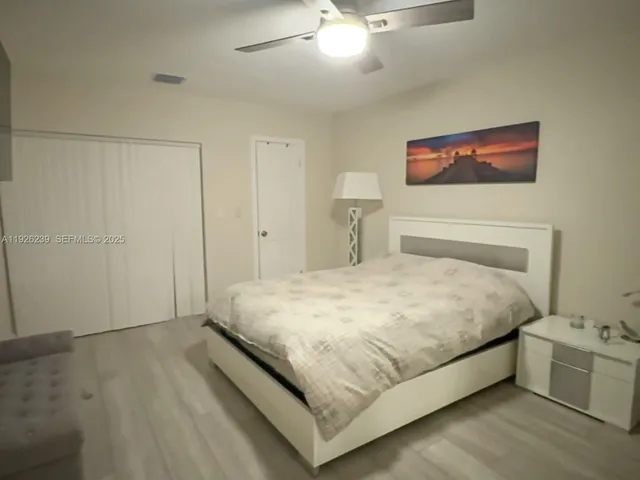 a large bed sitting in a bedroom and chandelier