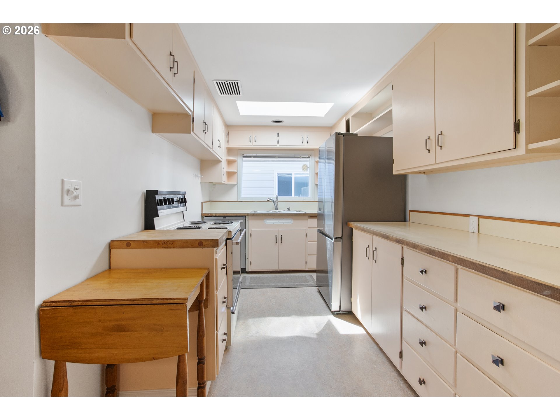 2840 Ferry Street Eugene, OR 97405 - Photo 11 of 35 a kitchen with cabinets and wooden floors