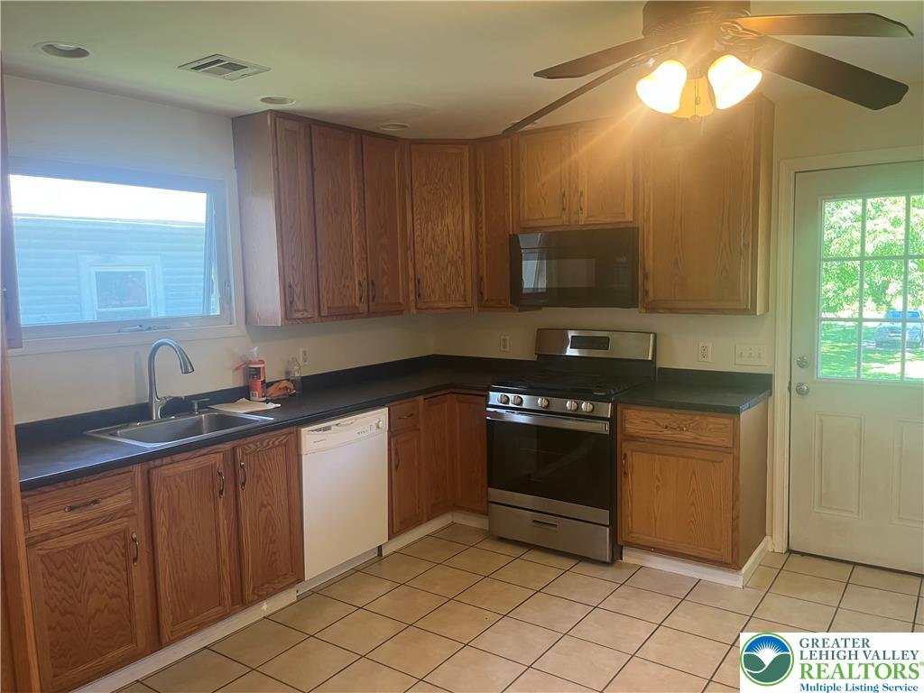 1839 Willow Park Road Bethlehem, PA 18020 - Photo 5 of 35 Functional kitchen with ample cabinetry and a convenient outdoor access point.