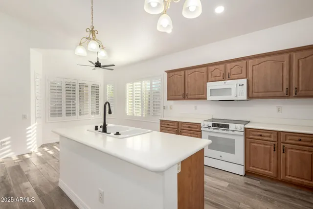 a kitchen with stainless steel appliances a sink stove and cabinets