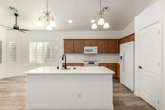 a kitchen with stainless steel appliances a refrigerator sink and cabinets