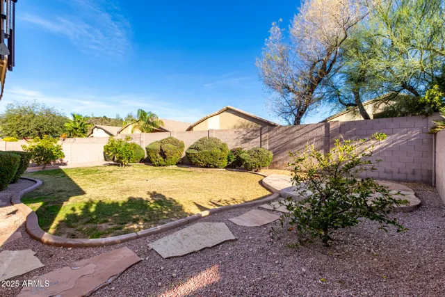 a view of a backyard with wooden fence