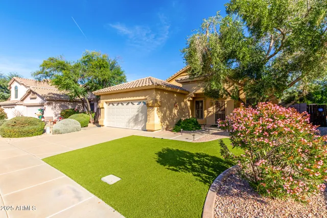a view of yellow house with swimming pool