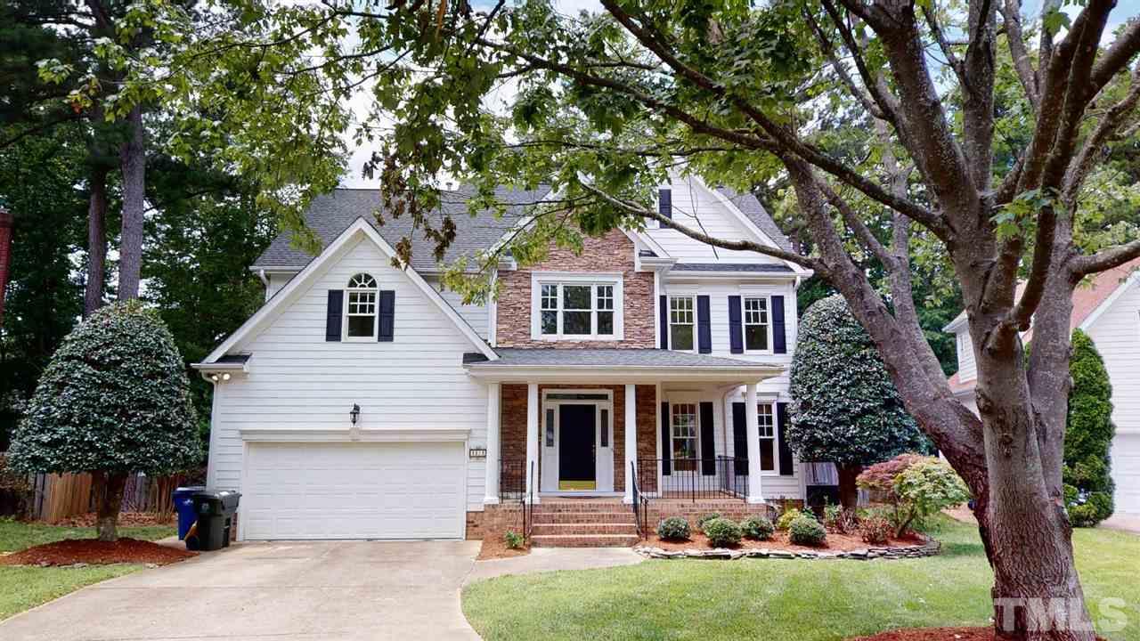 8212 Gaspari Court Raleigh, NC 27615 - Photo 1 of 18 a front view of a house with a garden and trees