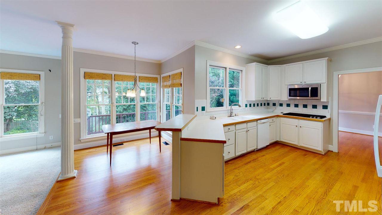 8212 Gaspari Court Raleigh, NC 27615 - Photo 2 of 18 a kitchen with a sink stove top oven and refrigerator
