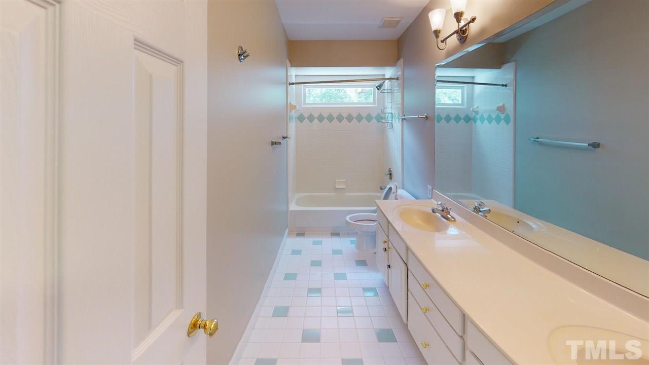 8212 Gaspari Court Raleigh, NC 27615 - Photo 16 of 18 a bathroom with a tub sink and shower