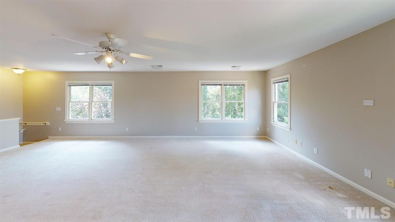 8212 Gaspari Court Raleigh, NC 27615 - Photo 17 of 18 an empty room with windows and ceiling fan