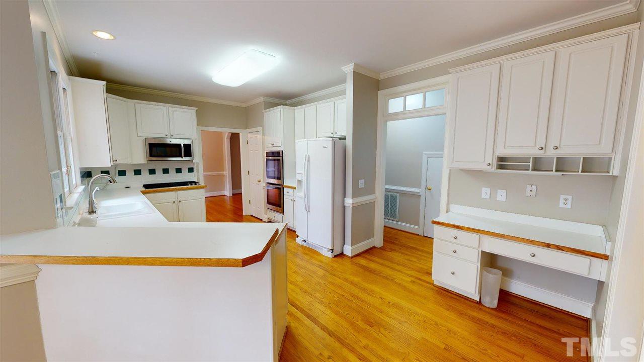 8212 Gaspari Court Raleigh, NC 27615 - Photo 3 of 18 a kitchen with stainless steel appliances granite countertop a refrigerator a stove and a sink