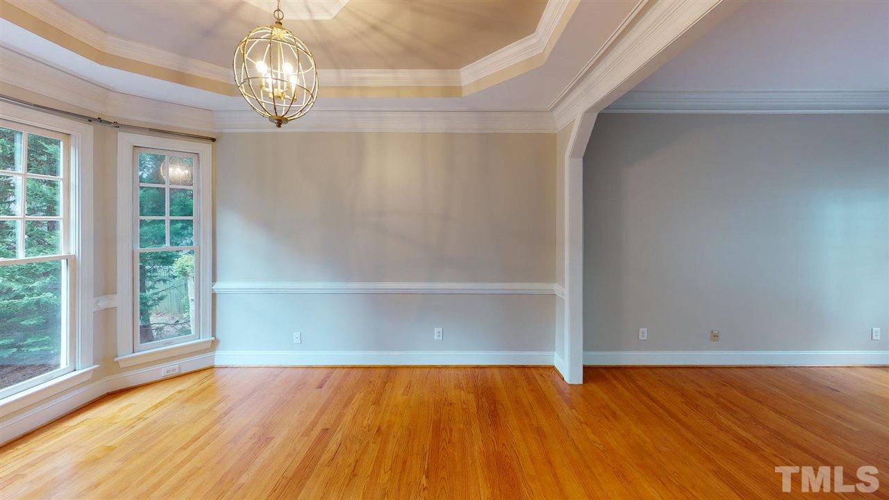8212 Gaspari Court Raleigh, NC 27615 - Photo 5 of 18 a view of empty room with wooden floor and fan