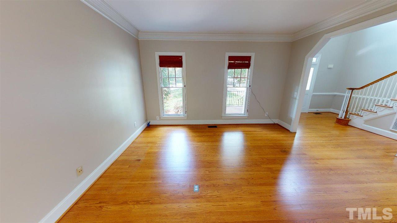8212 Gaspari Court Raleigh, NC 27615 - Photo 9 of 18 a view of empty room with wooden floor and window