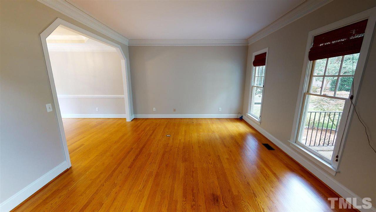 8212 Gaspari Court Raleigh, NC 27615 - Photo 10 of 18 a view of an empty room with wooden floor and a window