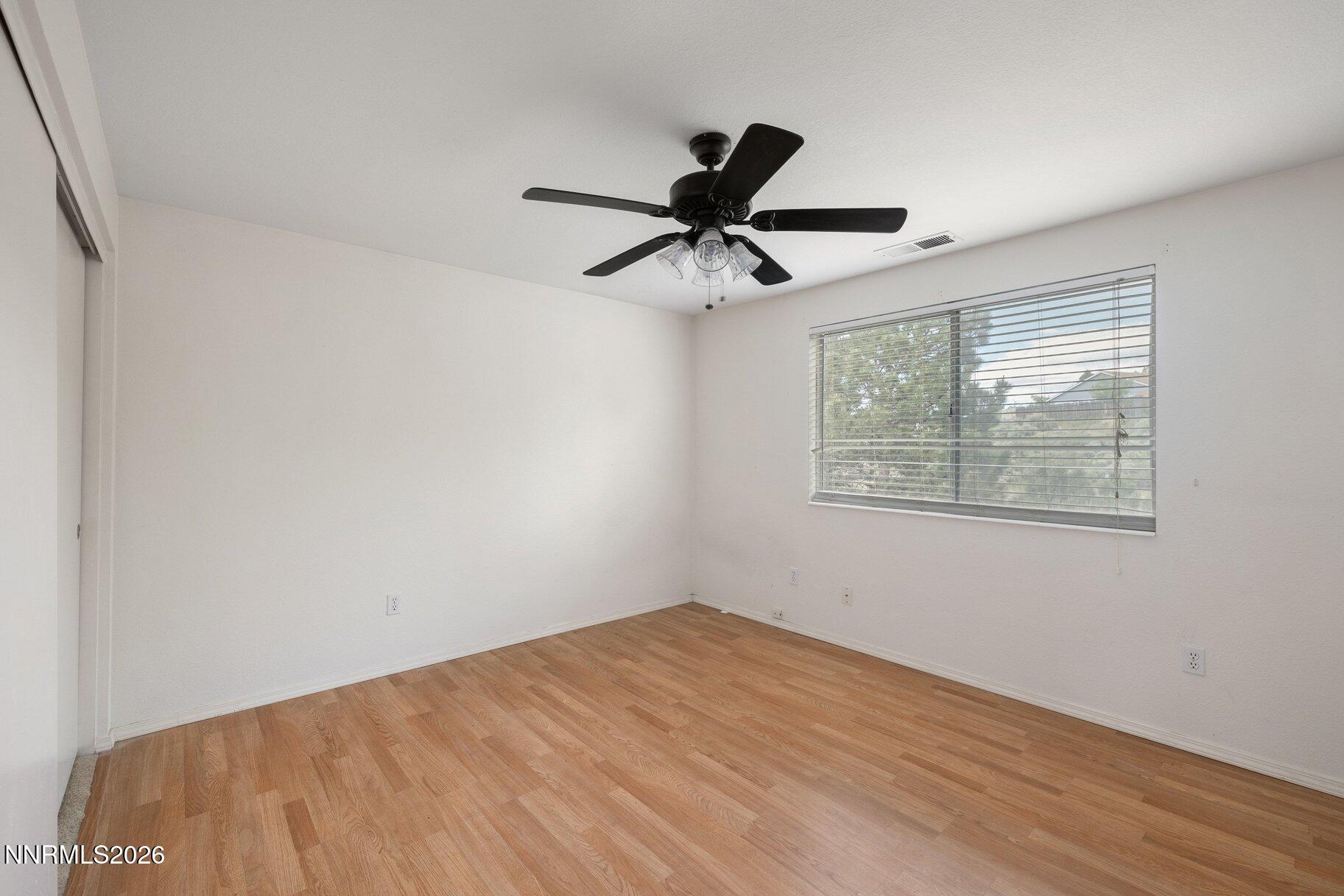 8486 Piper Place Reno, NV 89506 - Photo 21 of 80 a view of a big room with wooden floor and windows