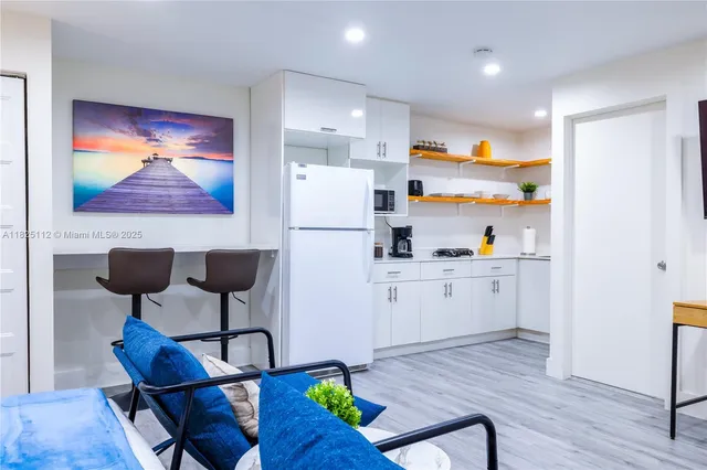 a kitchen with furniture wooden floor and wall painting