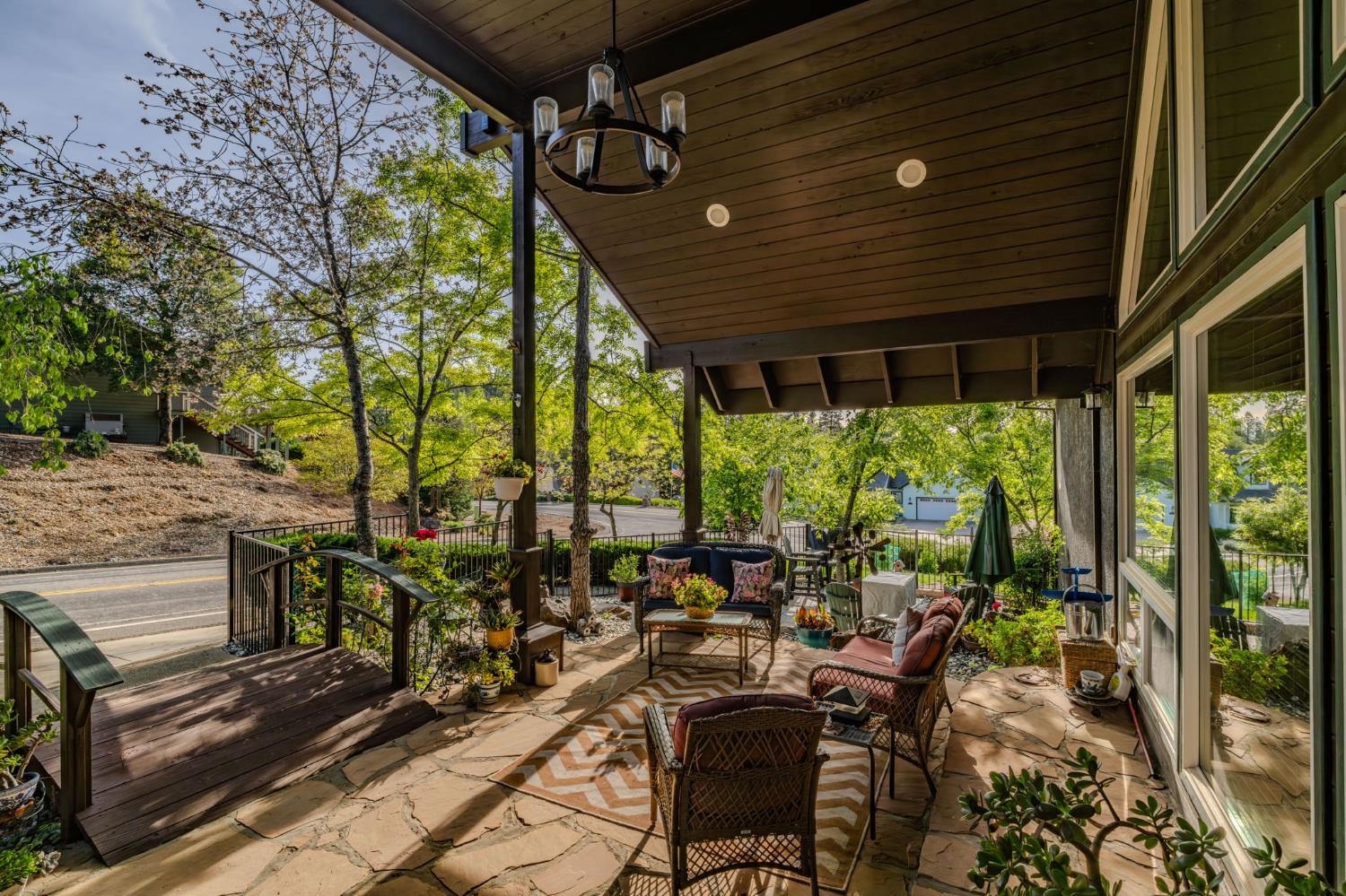 12091 Mierkey Road Jackson, CA 95642 - Photo 15 of 87 a view of a patio with table and chairs potted plants with floor to ceiling window