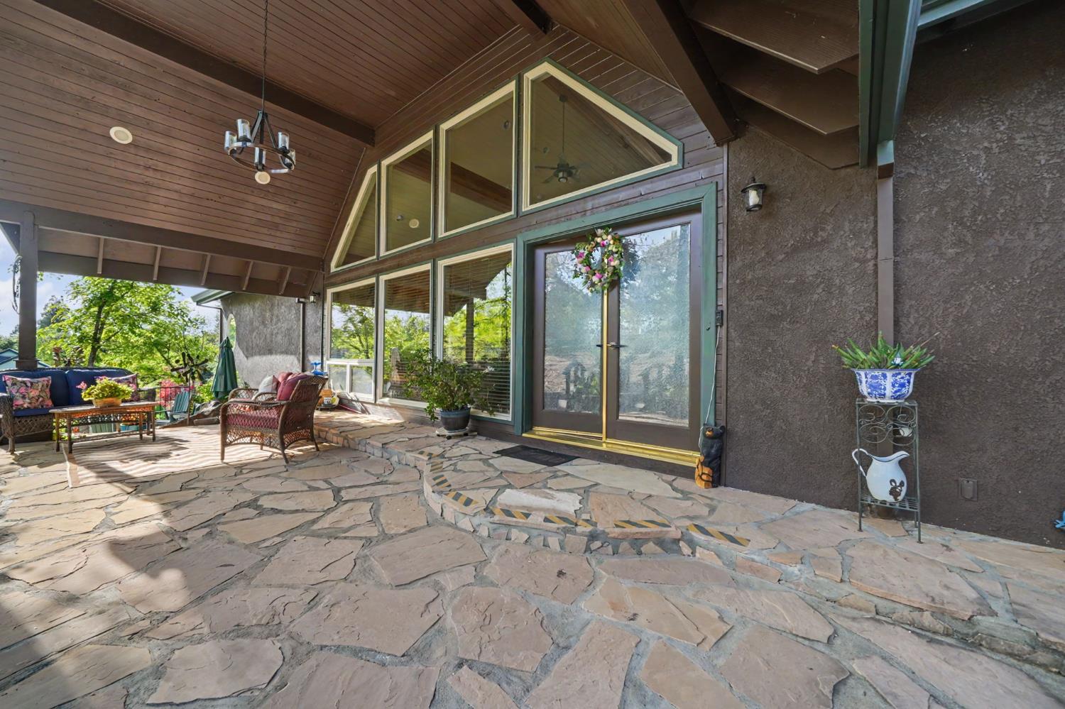 12091 Mierkey Road Jackson, CA 95642 - Photo 16 of 87 a view of a porch with chairs and potted plants