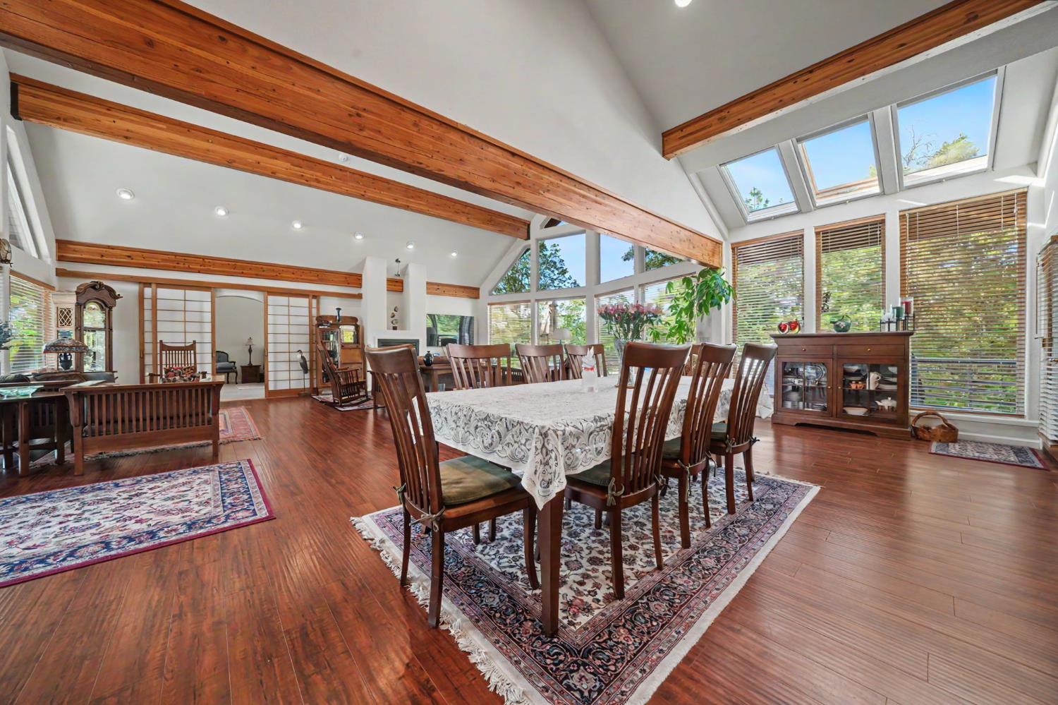 12091 Mierkey Road Jackson, CA 95642 - Photo 46 of 87 a dining room with furniture wooden floor and a rug
