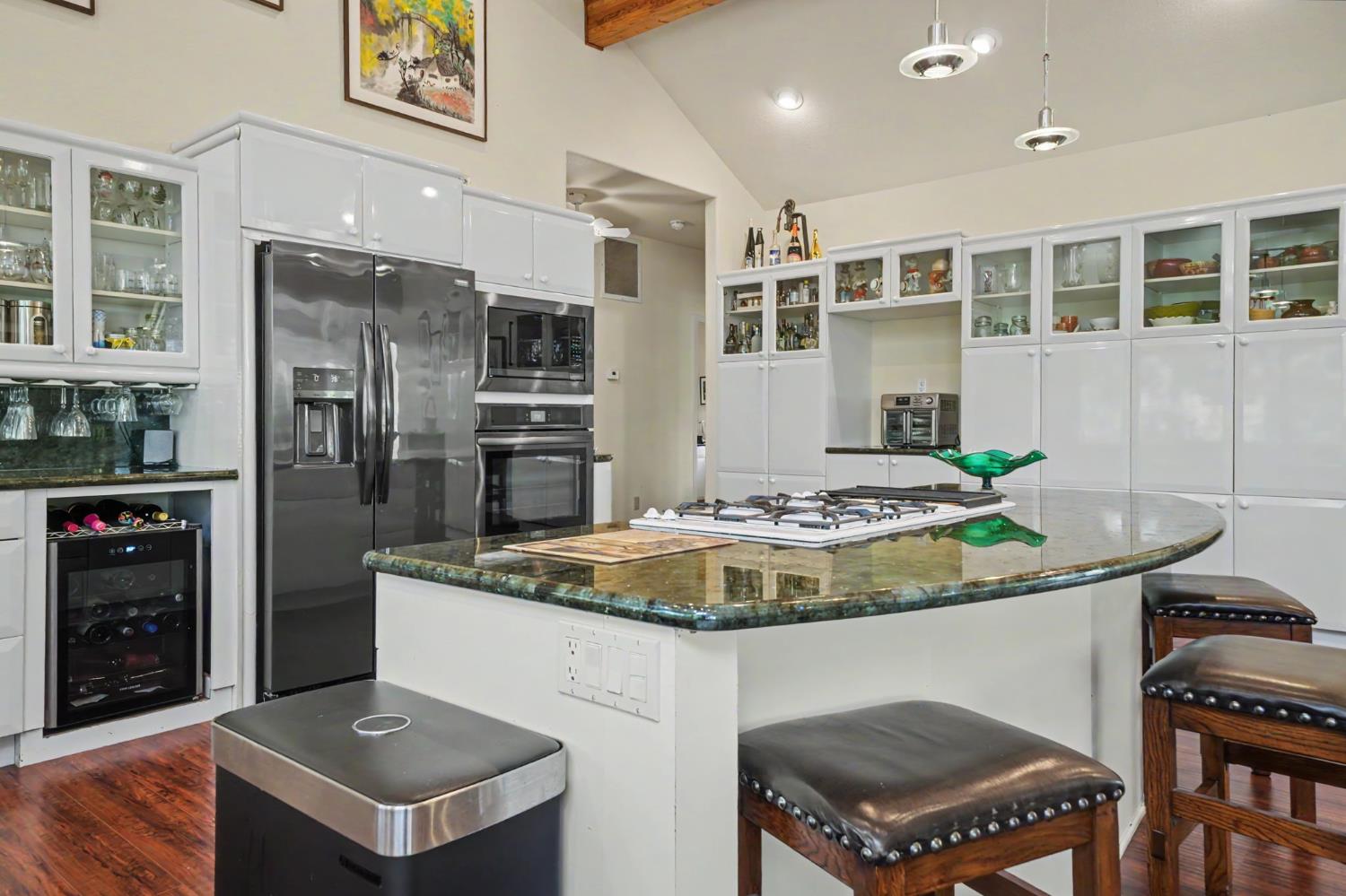12091 Mierkey Road Jackson, CA 95642 - Photo 49 of 87 a kitchen with kitchen island stainless steel appliances a stove a sink and a refrigerator