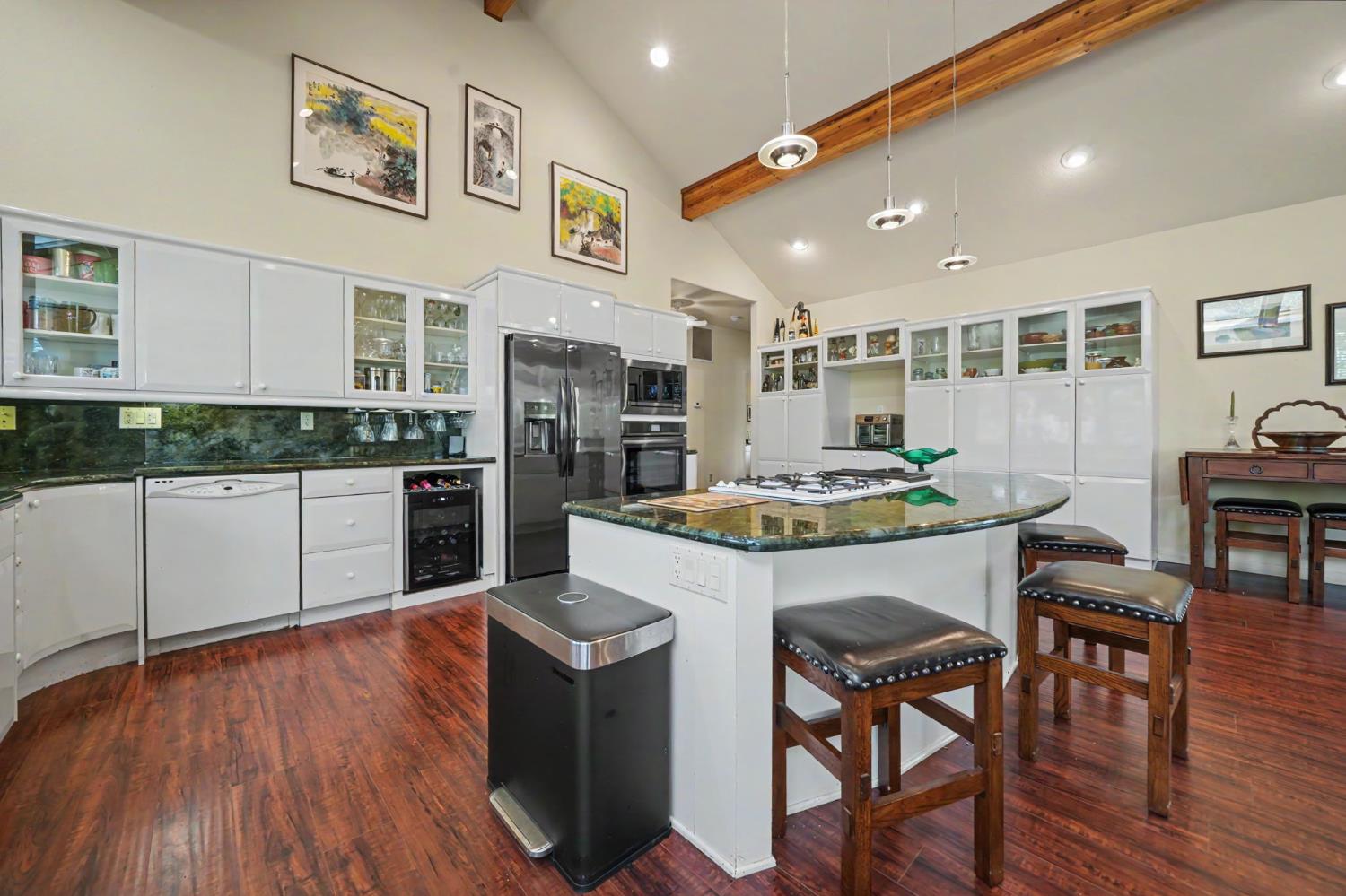 12091 Mierkey Road Jackson, CA 95642 - Photo 50 of 87 a kitchen with stainless steel appliances kitchen island granite countertop a table chairs and a refrigerator