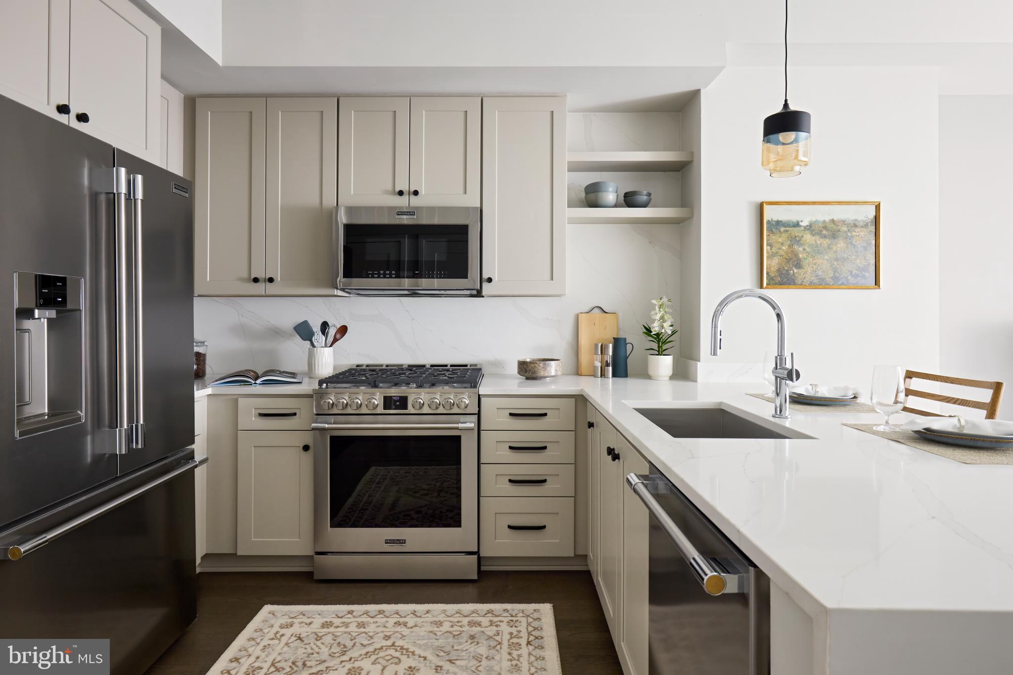 a kitchen with stainless steel appliances granite countertop a stove sink and refrigerator