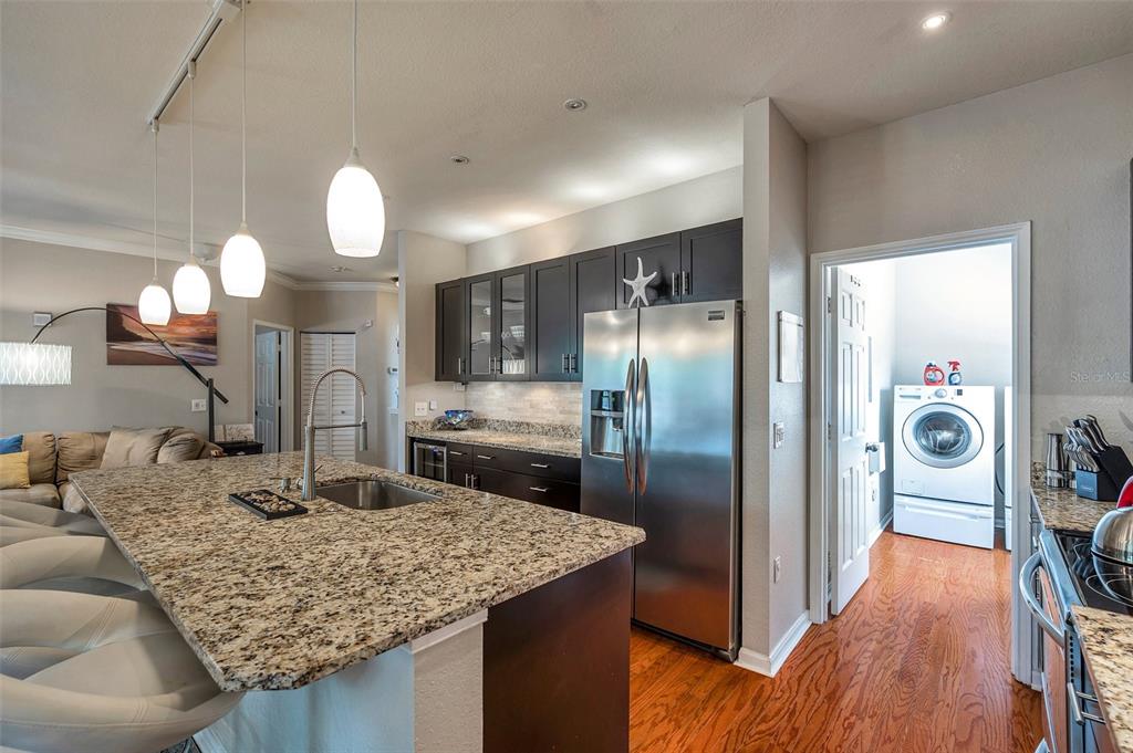 2245 Chianti Place, Unit 724 Palm Harbor, FL 34683 - Photo 18 of 76 a kitchen with stainless steel appliances granite countertop a sink refrigerator and stove