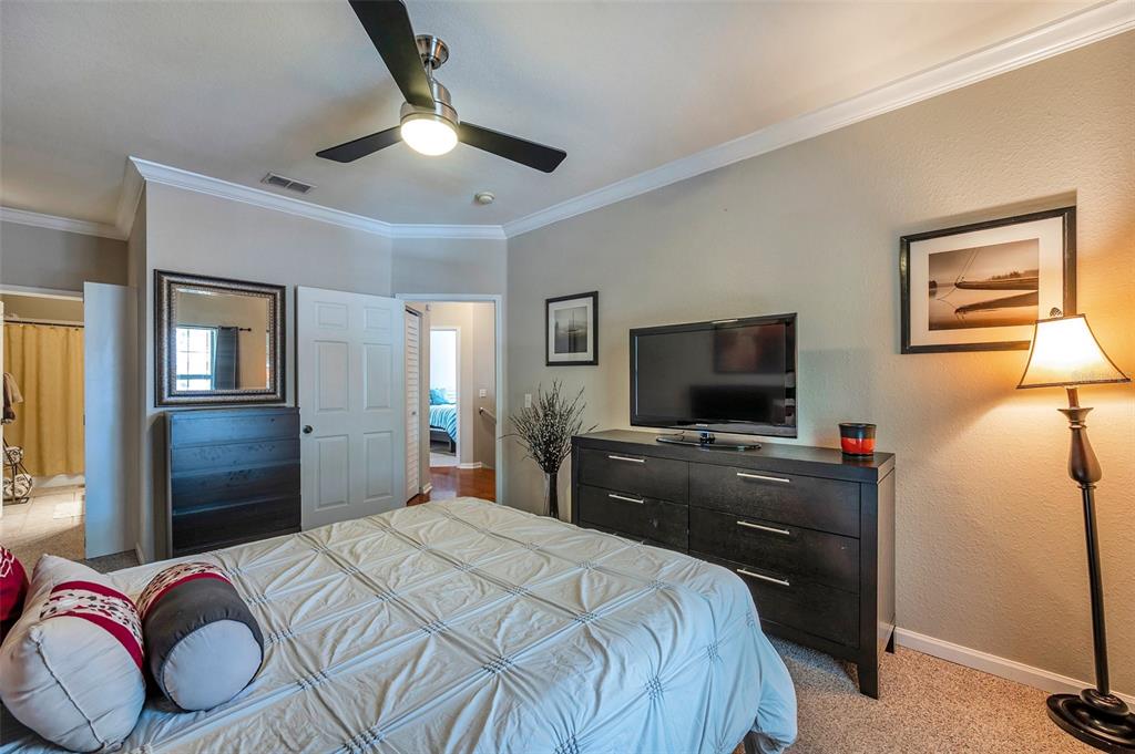 2245 Chianti Place, Unit 724 Palm Harbor, FL 34683 - Photo 23 of 76 a bedroom with a bed and a flat screen tv