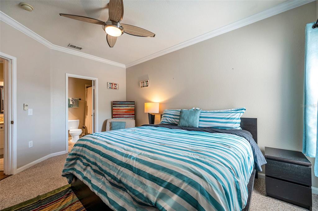 2245 Chianti Place, Unit 724 Palm Harbor, FL 34683 - Photo 30 of 76 a bedroom with bed and a chandelier