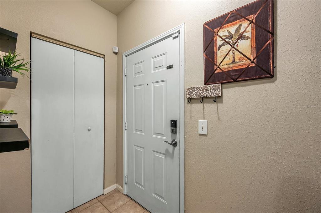 2245 Chianti Place, Unit 724 Palm Harbor, FL 34683 - Photo 3 of 76 a view of a hallway with wooden floor and closet